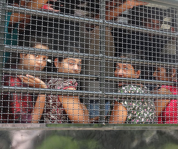 Children begind cage